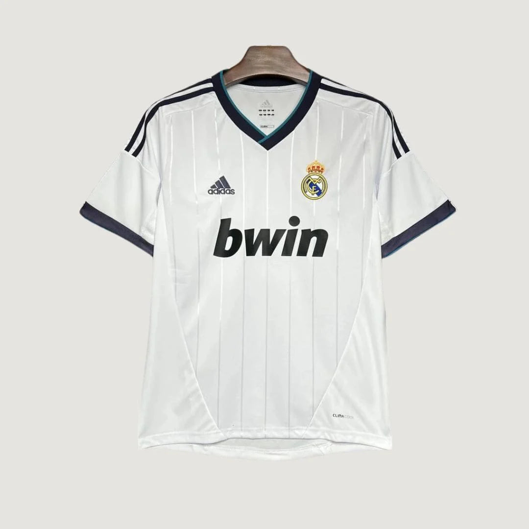 Maillot de foot blanc Adidas Real Madrid avec logo, sponsor bwin, col en V et détails noirs.