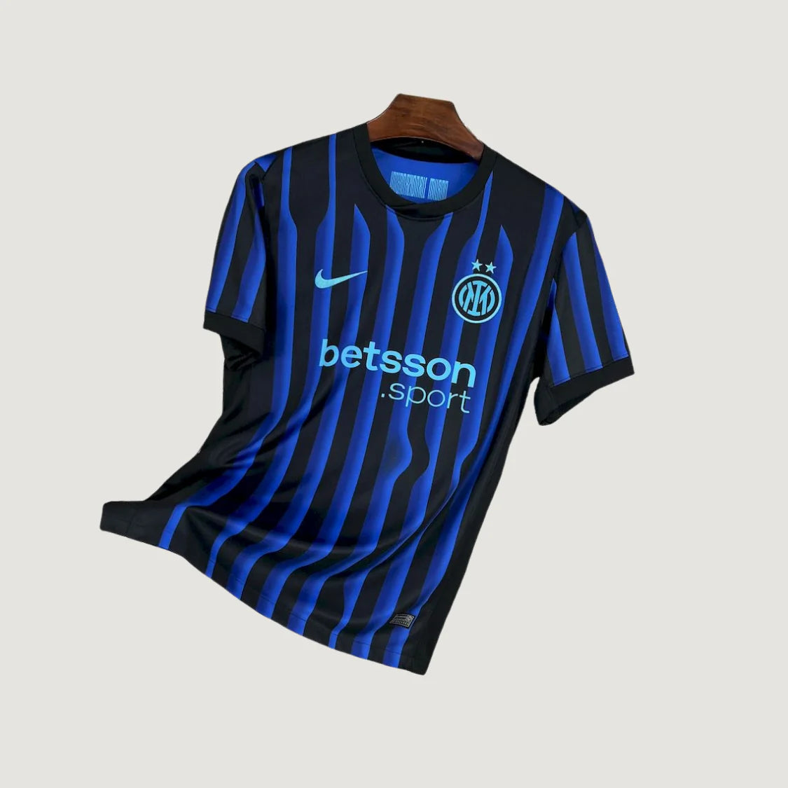 Maillot de foot homme noir et bleu rayé avec logo, sponsor et col rond, style moderne.